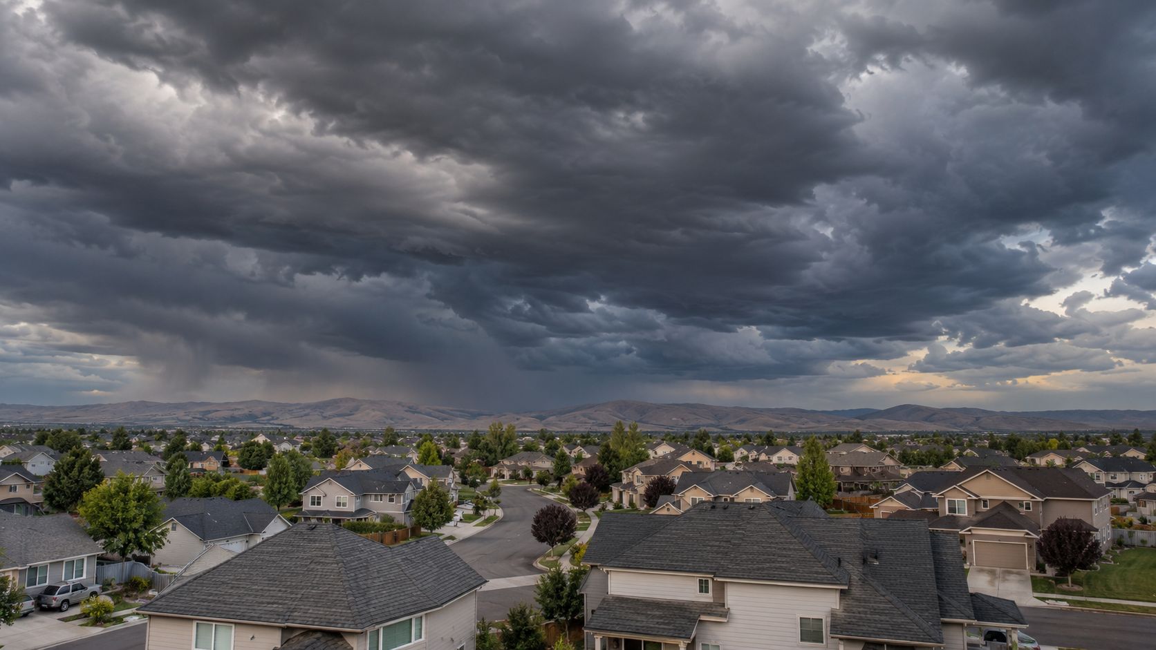 dark storm clouds over a residential neighborhood