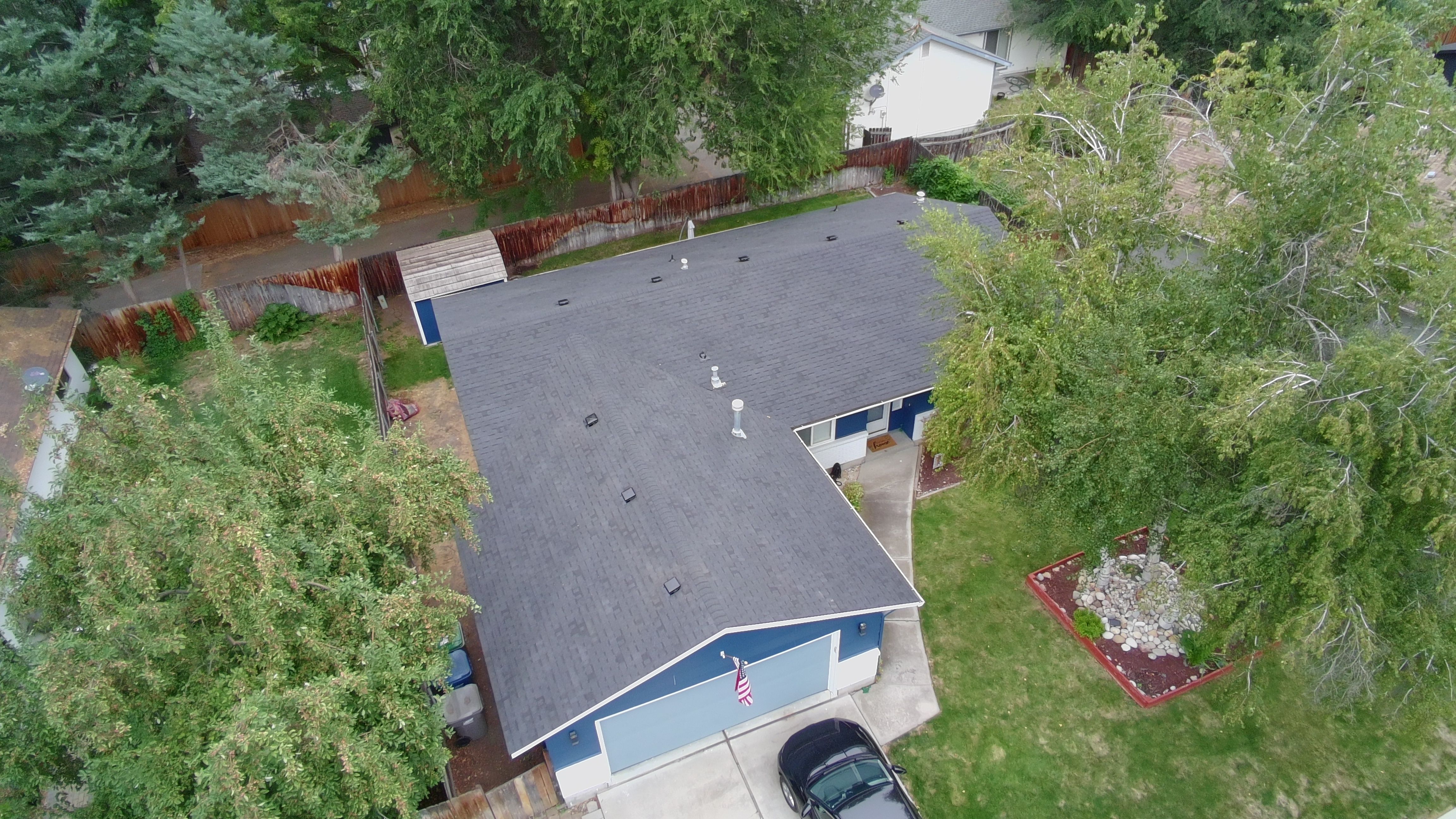 Aerial view of a completed asphalt shingle roof installation